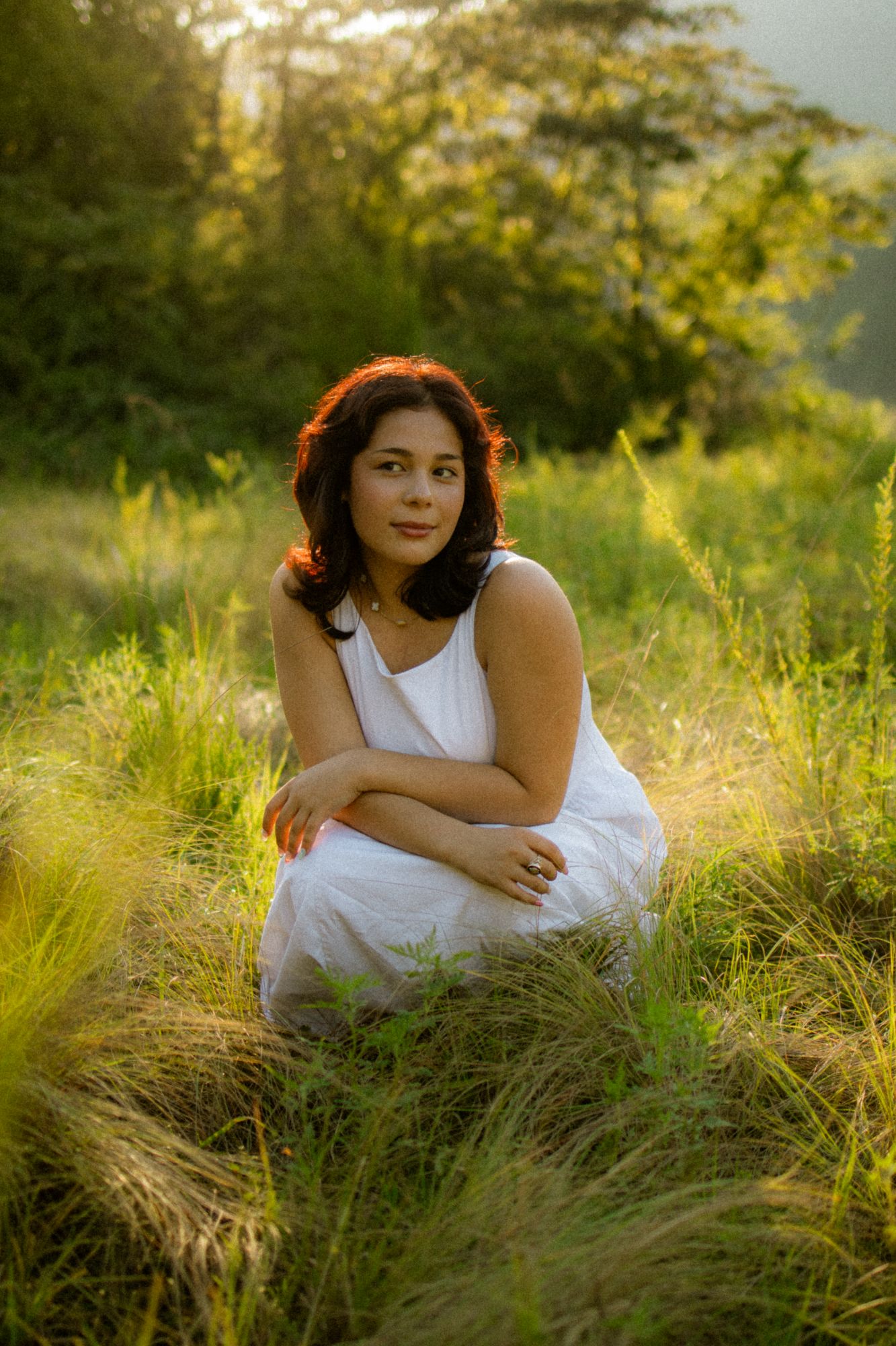 senior portrait sitting in a field